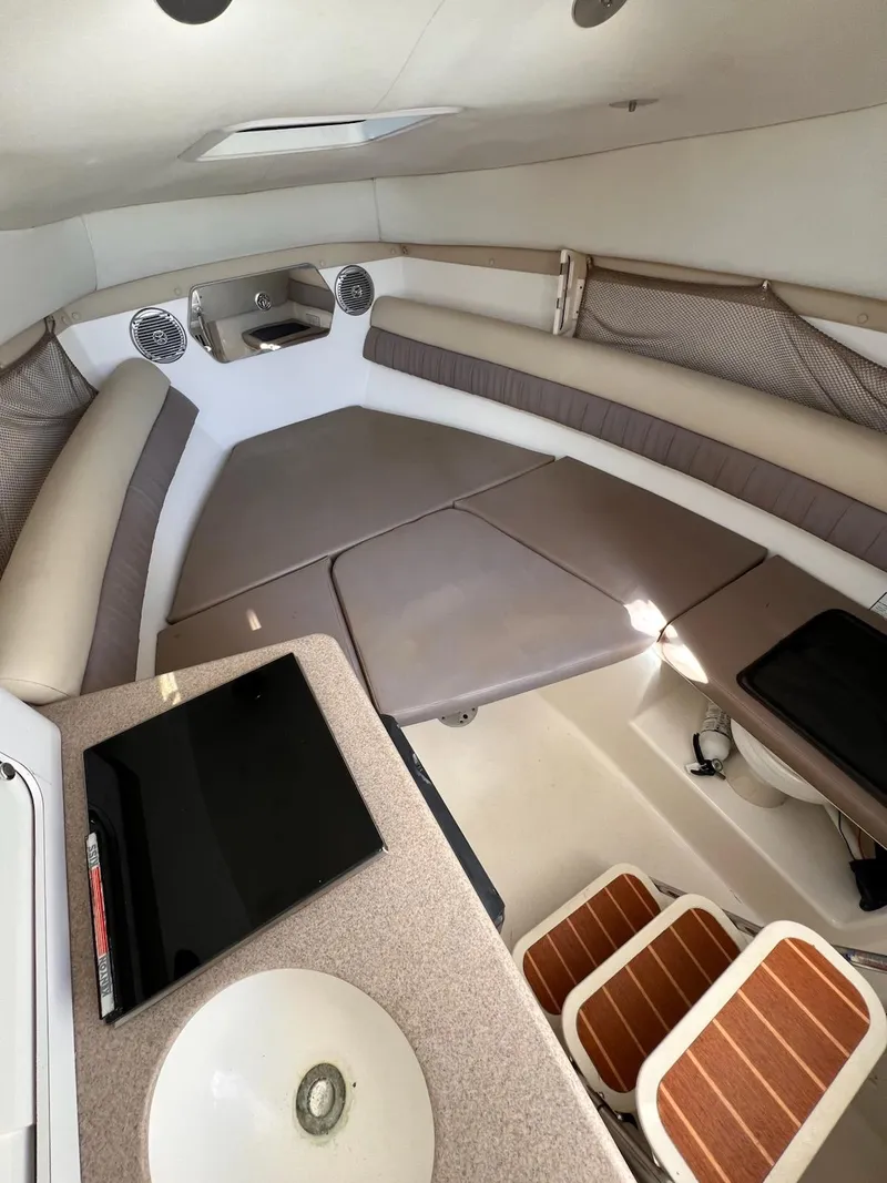 Slide: The Image of 2008 Century 2400 Walkaround cabin interior with seating, table, and sink. - 8