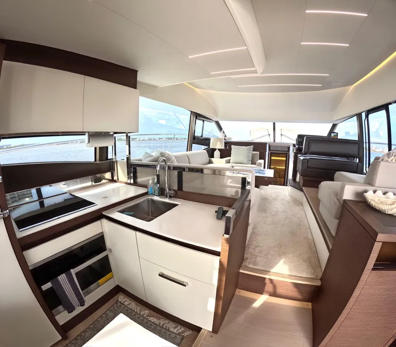 Slide: The Image of Luxurious interior of a 2019 Prestige 520 yacht with modern kitchen and seating area. - 14