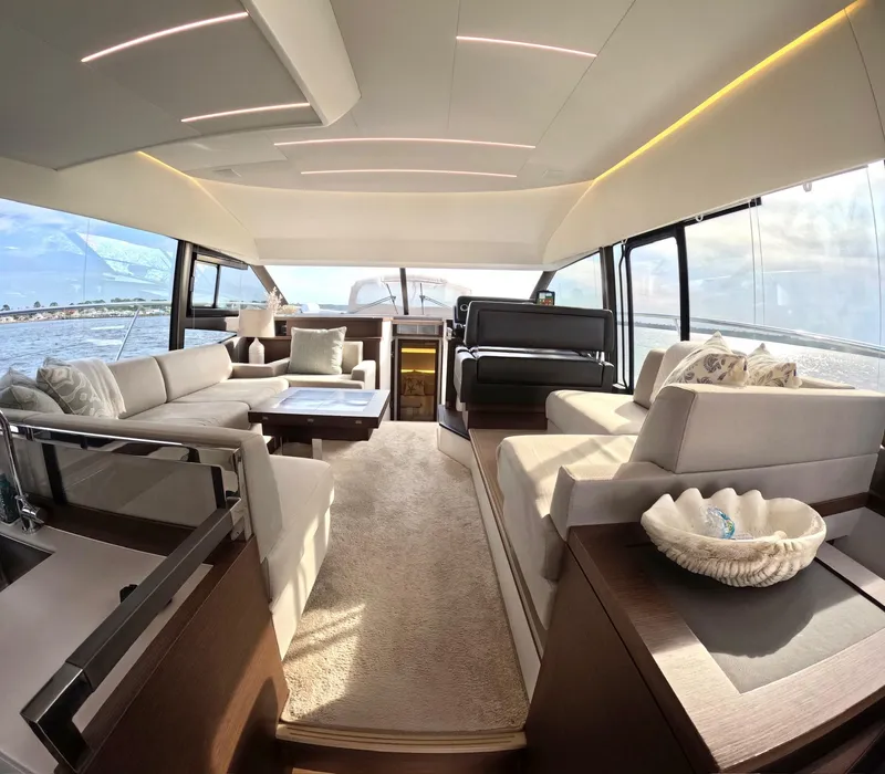 Slide: The Image of Luxurious interior of a 2019 Prestige 520 yacht with elegant seating and panoramic windows. - 16