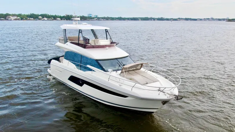 Slide: The Image of 2019 Prestige 520 yacht cruising on a calm river. - 2