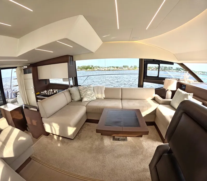 Slide: The Image of Luxurious interior of a 2019 Prestige 520 yacht with elegant seating and scenic water view. - 21