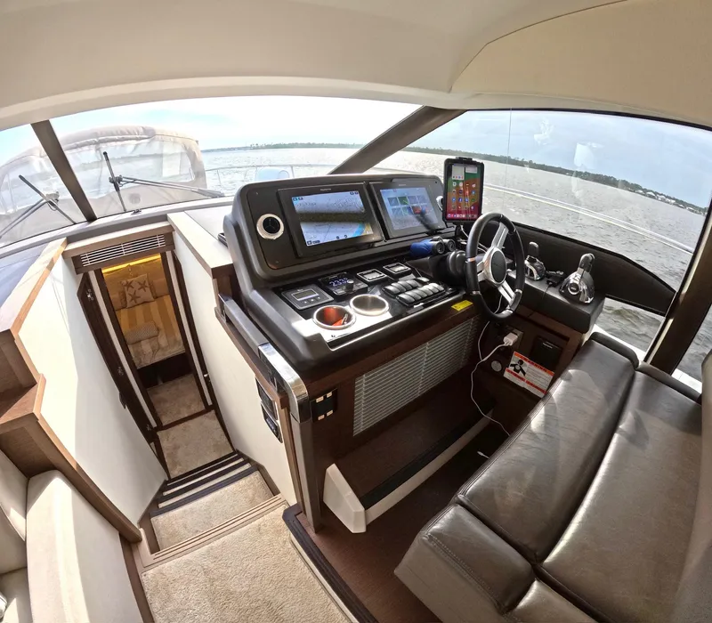 Slide: The Image of Interior of a 2019 Prestige 520 yacht cockpit with navigation controls and seating. - 27
