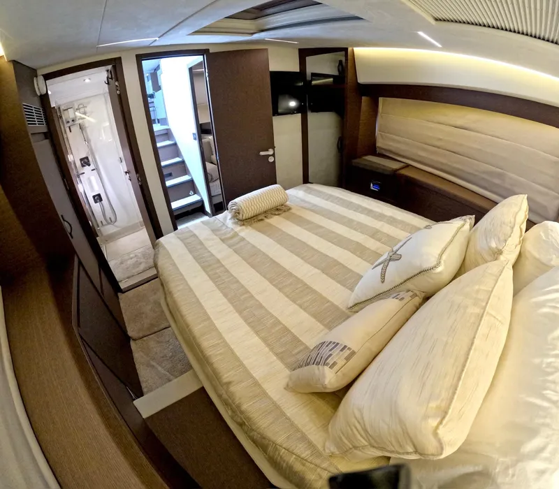 Slide: The Image of Luxurious bedroom interior of 2019 Prestige 520 yacht with striped bedding and elegant decor. - 30