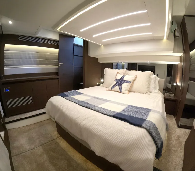 Slide: The Image of Luxurious bedroom interior of 2019 Prestige 520 yacht with modern design and cozy bedding. - 33