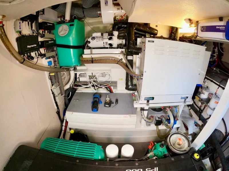 Slide: The Image of Engine room of a 2019 Prestige 520 yacht, showcasing complex machinery and equipment. - 41