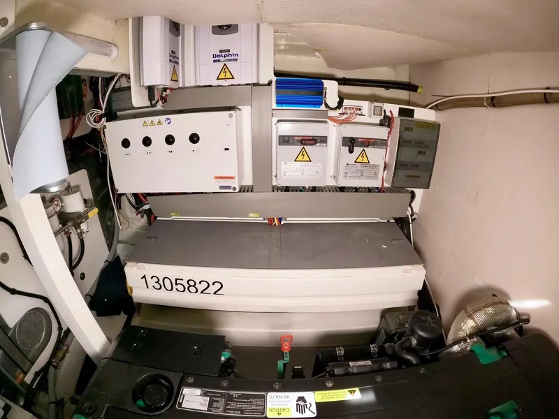 Slide: The Image of Engine room of a 2019 Prestige 520 yacht, showcasing electrical systems and components. - 42