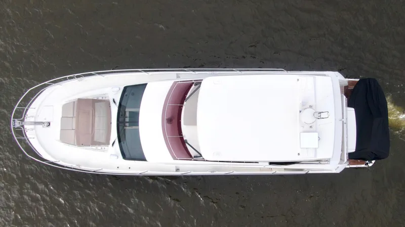 Slide: The Image of Aerial view of a 2019 Prestige 520 yacht cruising on water. - 5