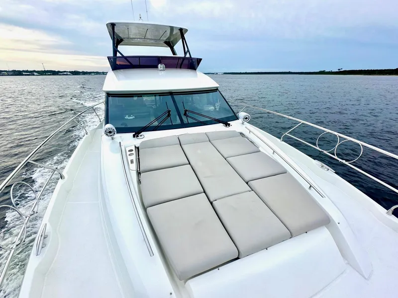 Slide: The Image of 2019 Prestige 520 yacht cruising on calm waters with spacious sunbathing deck. - 7