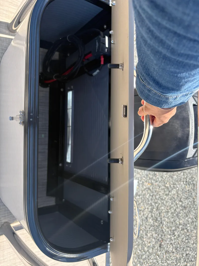 Slide: The Image of 2018 Avalon LSZ Quad Lounger storage compartment with open lid and visible interior. - 10