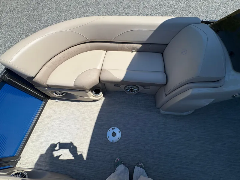 Slide: The Image of 2018 Avalon LSZ Quad Lounger boat interior with beige seating and gray flooring. - 14