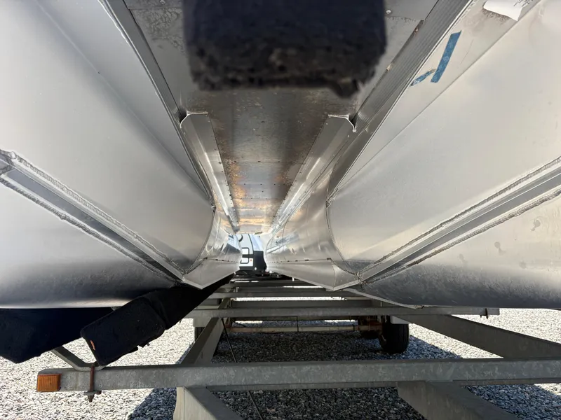 Slide: The Image of Underside view of a 2018 Avalon LSZ Quad Lounger pontoon boat on a trailer. - 16