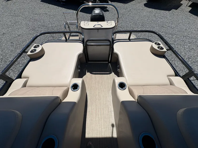 Slide: The Image of 2018 Avalon LSZ Quad Lounger boat interior with beige seating and cup holders. - 18