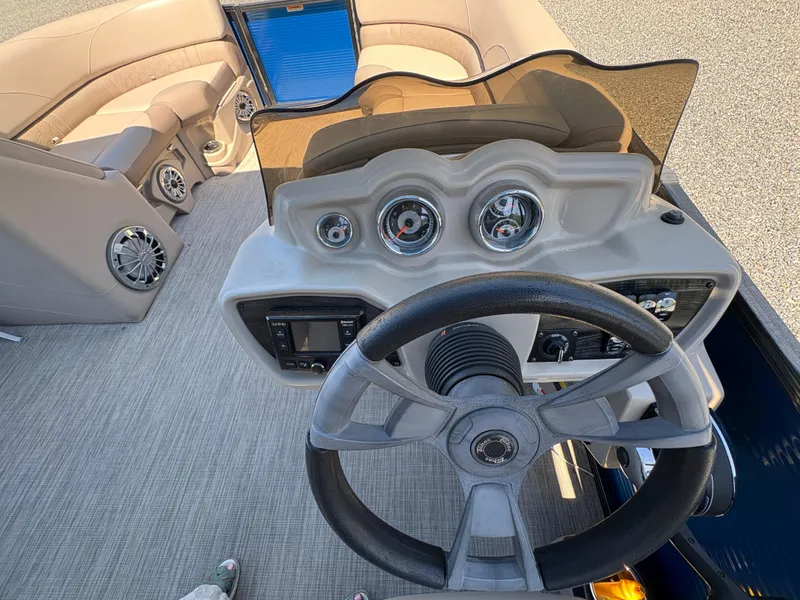 Slide: The Image of 2018 Avalon LSZ Quad Lounger boat dashboard with steering wheel and gauges. - 19