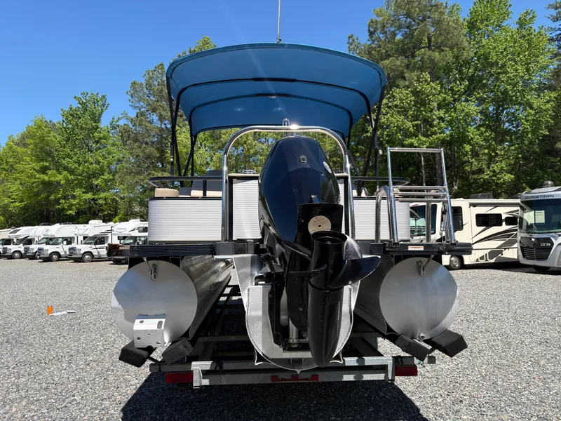 Slide: The Image of 2018 Avalon LSZ Quad Lounger 24' pontoon boat with canopy, parked on gravel lot. - 26