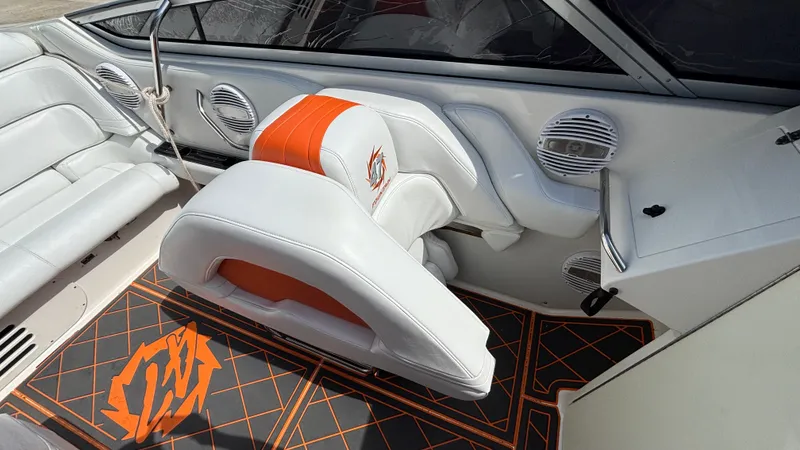 Slide: The Image of 2003 Fountain 47 Lightning boat interior with white and orange seating, custom flooring, and speaker system. - 10