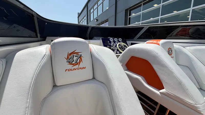 Slide: The Image of 2003 Fountain 47 Lightning boat interior with white and orange seating, dashboard view. - 15