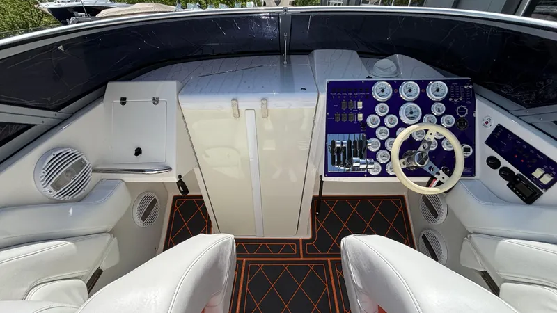 Slide: The Image of 2003 Fountain 47 Lightning boat cockpit with steering wheel and control panel. - 18