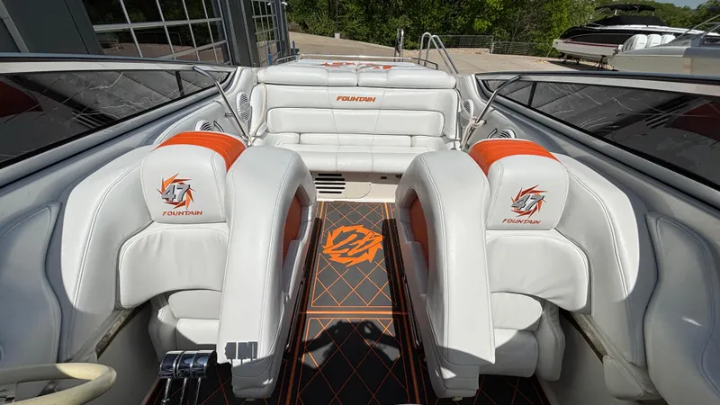 Slide: The Image of 2003 Fountain 47 Lightning boat interior with white and orange seating, sleek design. - 19