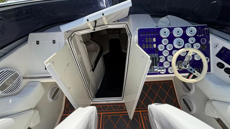 Slide: The Image of 2003 Fountain 47 Lightning boat interior with open cabin door and control panel. - 20