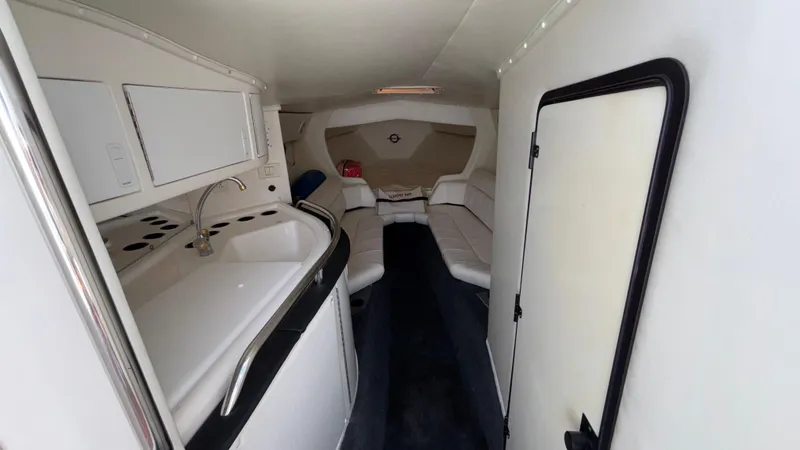 Slide: The Image of 2003 Fountain 47 Lightning boat interior with kitchenette and seating area. - 21