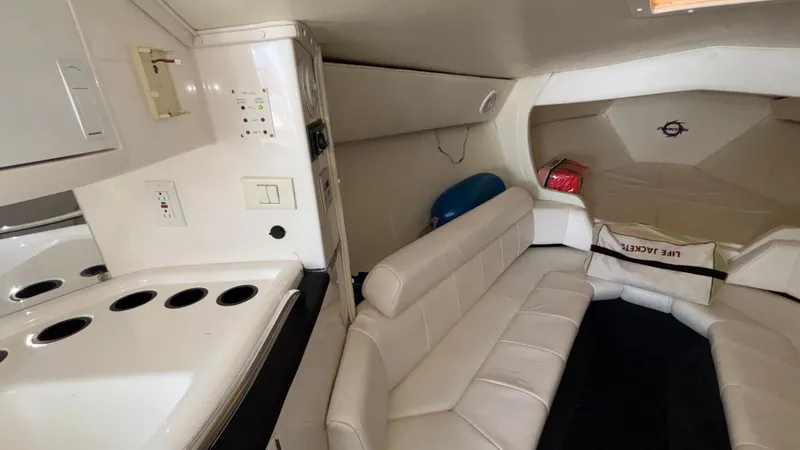 Slide: The Image of 2003 Fountain 47 Lightning boat interior with white seating and compact kitchenette. - 24