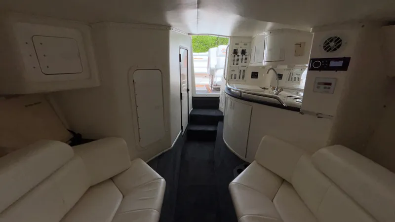 Slide: The Image of Interior of 2003 Fountain 47 Lightning boat with white seating and compact kitchen area. - 27
