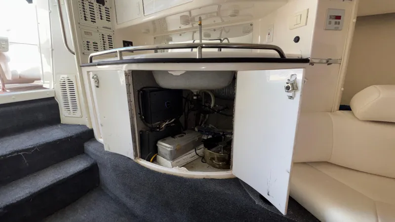 Slide: The Image of 2003 Fountain 47 Lightning interior with open cabinet showing storage and equipment. - 30