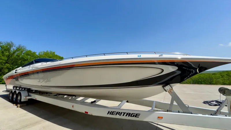 Slide: The Image of 2003 Fountain 47 Lightning speedboat on trailer under clear blue sky. - 4