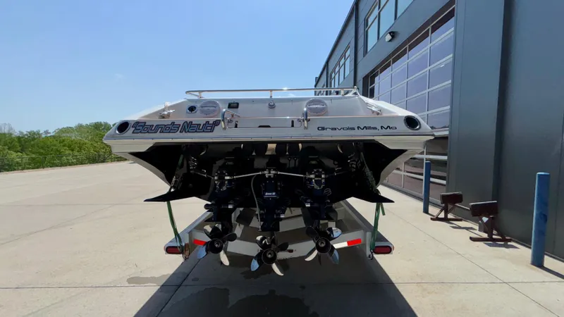 Slide: The Image of 2003 Fountain 47 Lightning boat, rear view, parked outside a building. - 5