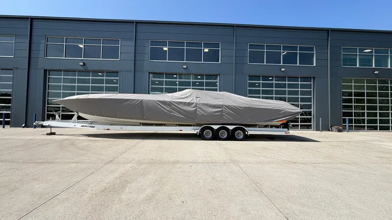 Slide: The Image of Covered 2003 Fountain 47 Lightning boat on trailer outside industrial building. - 6