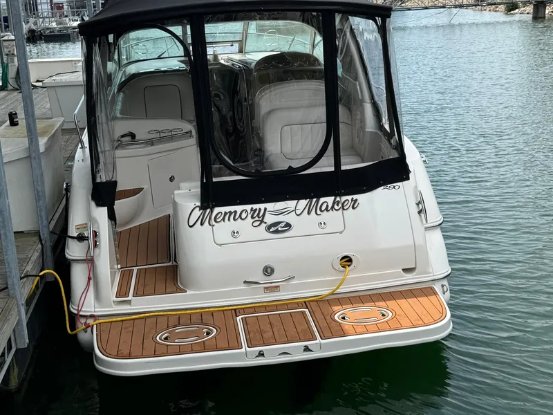 Slide: The Image of 2001 Sea Ray 290 Sundancer boat docked, featuring teak deck and "Memory Maker" name. - 17