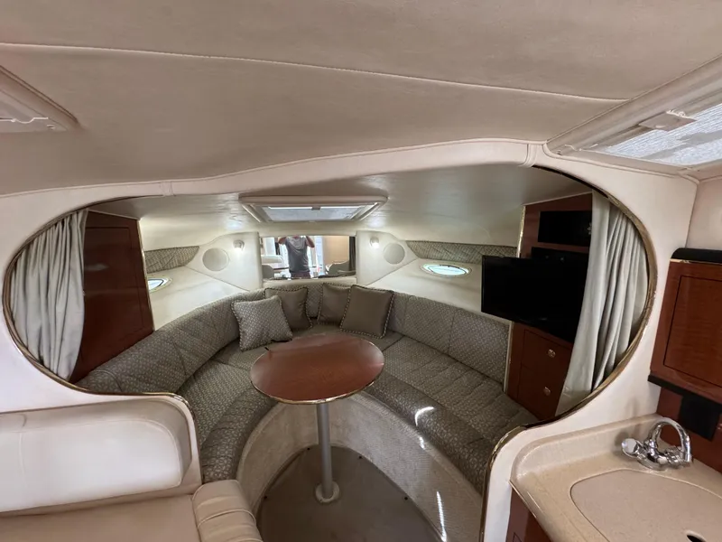 Slide: The Image of Interior of 2001 Sea Ray 290 Sundancer yacht with cozy seating and table. - 22