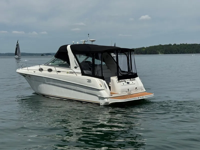 Slide: The Image of 2001 Sea Ray 290 Sundancer boat on calm lake waters. - 5