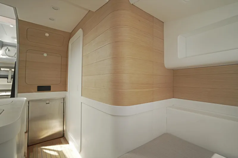 Slide: The Image of Interior of 2023 Novamarine Black Shiver 160, featuring modern wood paneling and sleek design. - 13