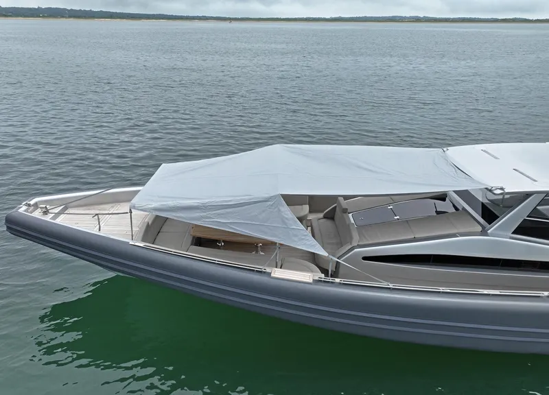 Slide: The Image of Novamarine Black Shiver 160 yacht, 2023 model, anchored on calm waters with a sleek design. - 5