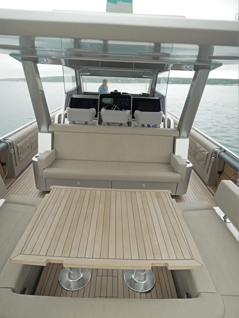 Slide: The Image of 2023 Novamarine Black Shiver 160 yacht interior with sleek seating and wooden table. - 9