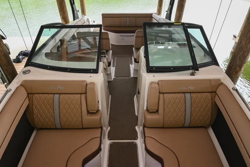 Slide: The Image of 2016 Sea Ray 270 Sundeck interior with tan leather seating and dual windshields. - 10