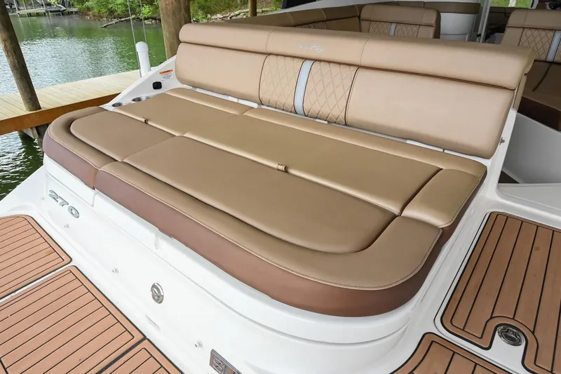 Slide: The Image of 2016 Sea Ray 270 Sundeck boat with spacious tan seating and teak-style flooring. - 12