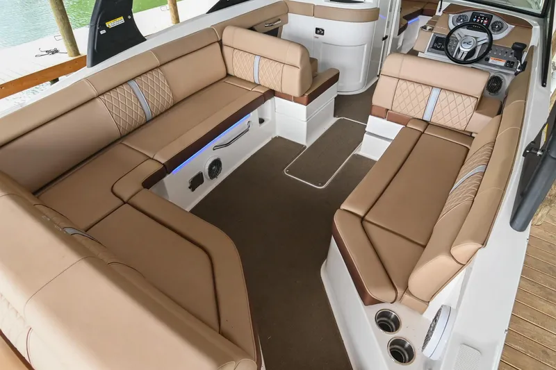Slide: The Image of 2016 Sea Ray 270 Sundeck interior with spacious tan seating and modern dashboard. - 14