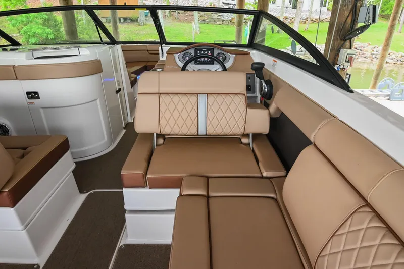 Slide: The Image of 2016 Sea Ray 270 Sundeck interior with tan leather seating and modern dashboard. - 18