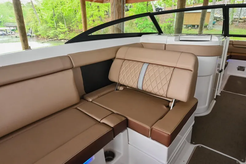 Slide: The Image of 2016 Sea Ray 270 Sundeck interior with brown leather seating and elegant design. - 22