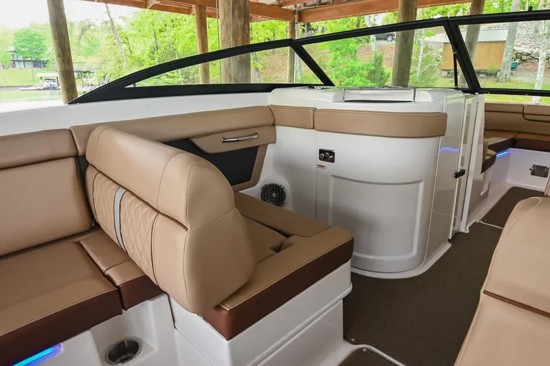 Slide: The Image of 2016 Sea Ray 270 Sundeck interior with tan seating and modern design. - 24