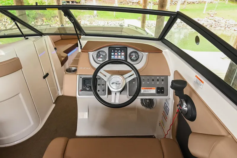 Slide: The Image of 2016 Sea Ray 270 Sundeck helm with steering wheel and control panel. - 27