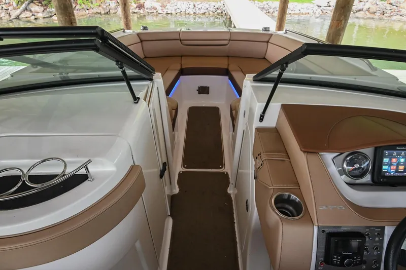 Slide: The Image of 2016 Sea Ray 270 Sundeck interior with tan seating and modern dashboard. - 31