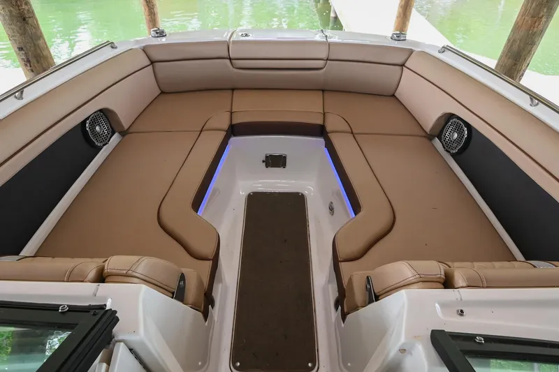 Slide: The Image of Interior of 2016 Sea Ray 270 Sundeck with tan seating and blue accent lighting. - 32
