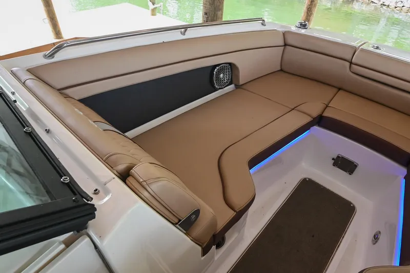 Slide: The Image of Luxurious seating on 2016 Sea Ray 270 Sundeck boat with tan upholstery and ambient lighting. - 33