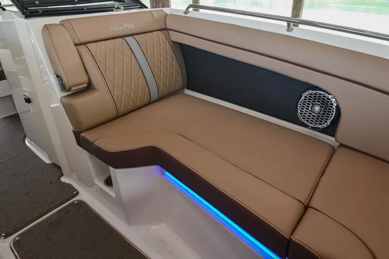 Slide: The Image of 2016 Sea Ray 270 Sundeck interior with tan seating and blue LED lighting. - 34