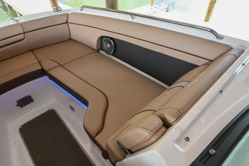 Slide: The Image of 2016 Sea Ray 270 Sundeck interior with tan seating and speaker. - 35