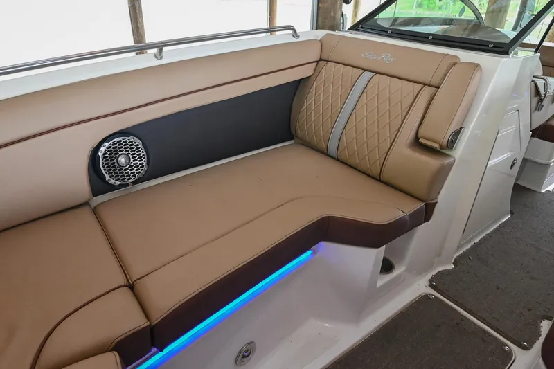 Slide: The Image of 2016 Sea Ray 270 Sundeck interior with tan seating and blue LED lighting. - 36