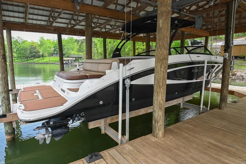Slide: The Image of 2016 Sea Ray 270 Sundeck boat docked in a covered marina. - 6